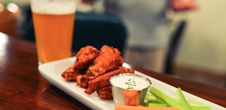 Photo of a beer and chicken wings
